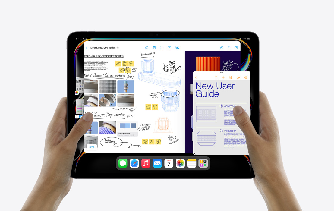 A pair of hands holding an iPad Pro showcasing Stage Manager to multitask between Calendar, Freeform, Mail, Pages and the Photos app.